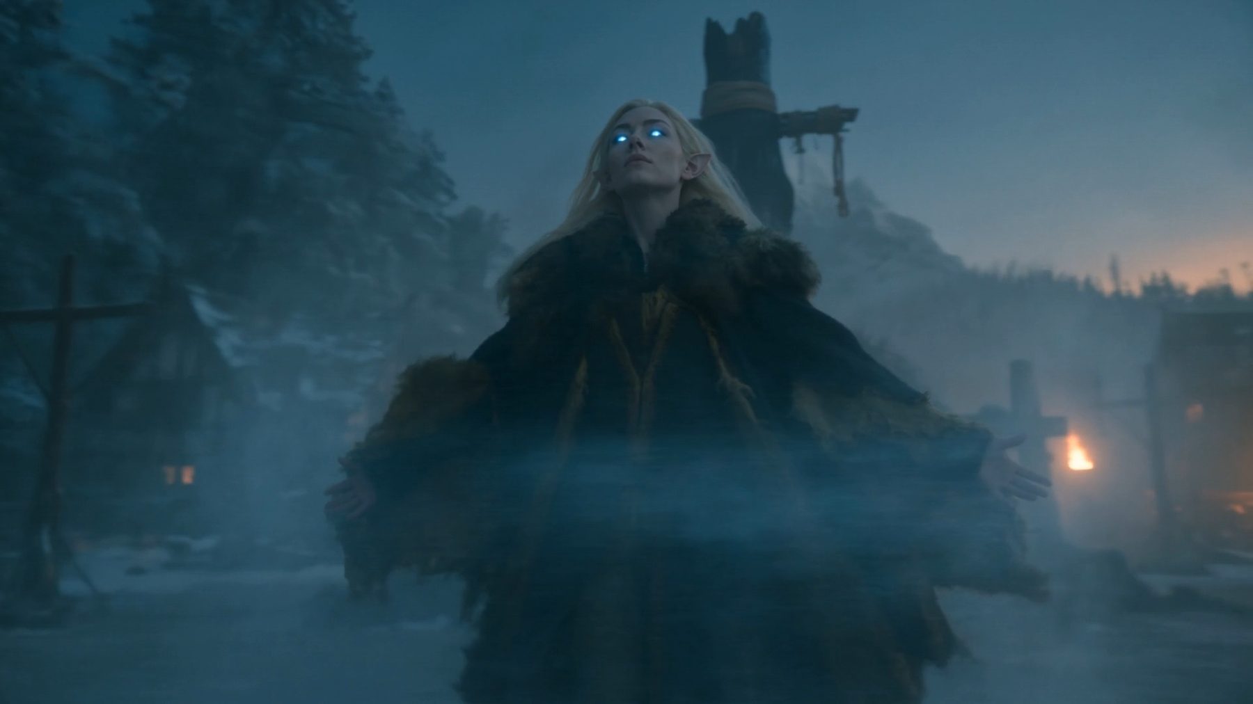 Seedance still — Aelira arms open, eyes glowing blue, frost storm rising around her